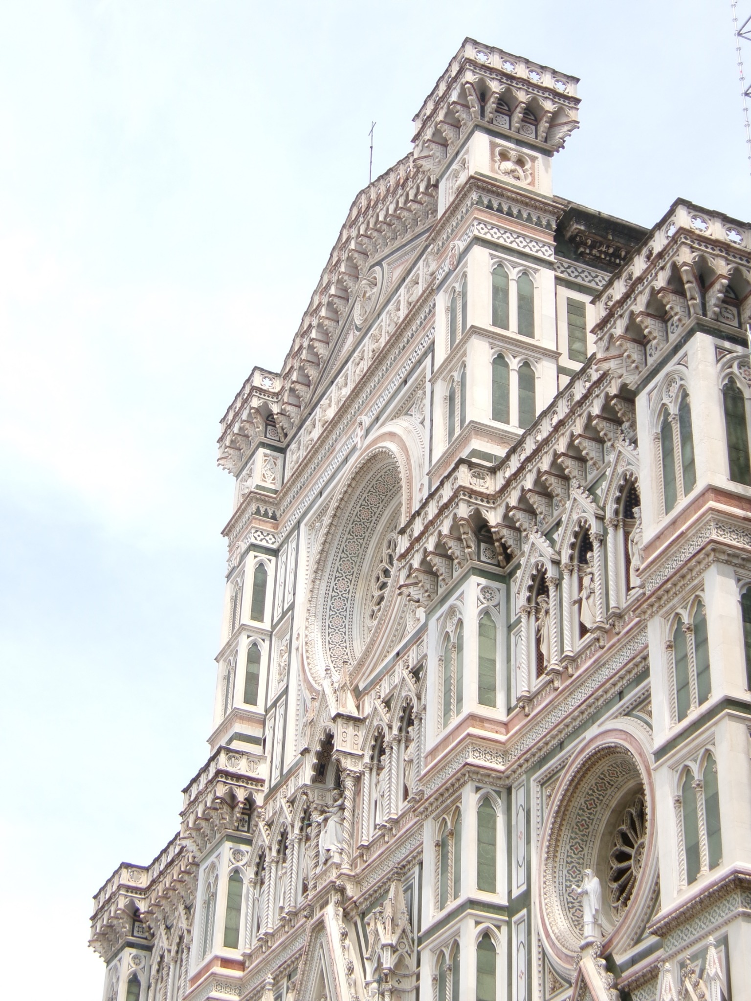 An ornate white and green stone facade viewed from below