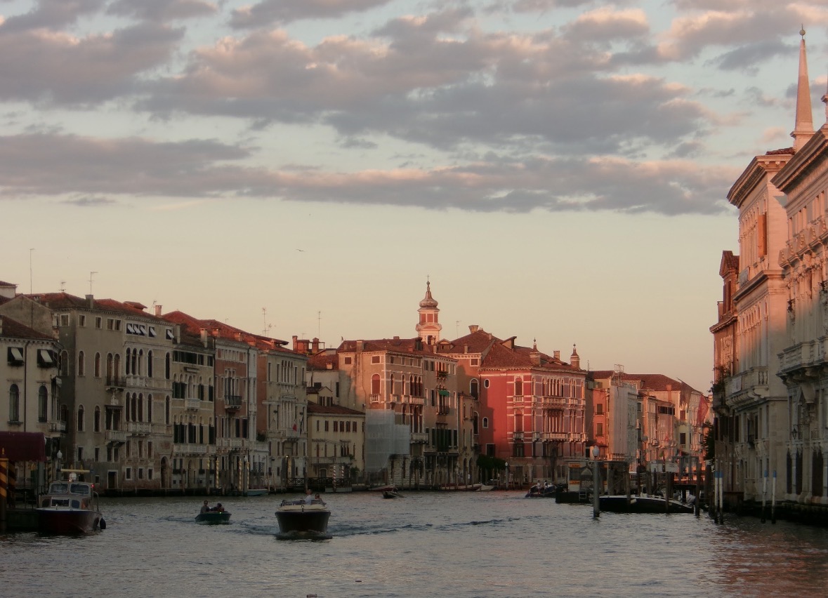 Canal-front buildings illuminated by warm evening light